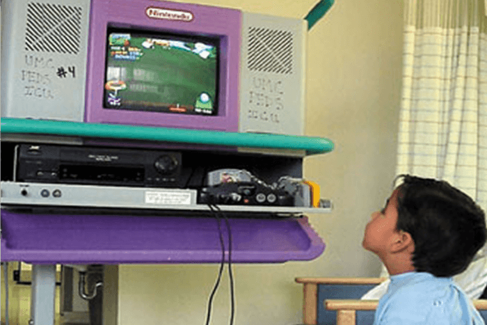 A seriously ill child enjoying video games on our Starlight Nintendo 64 console in the hospital (1998). 